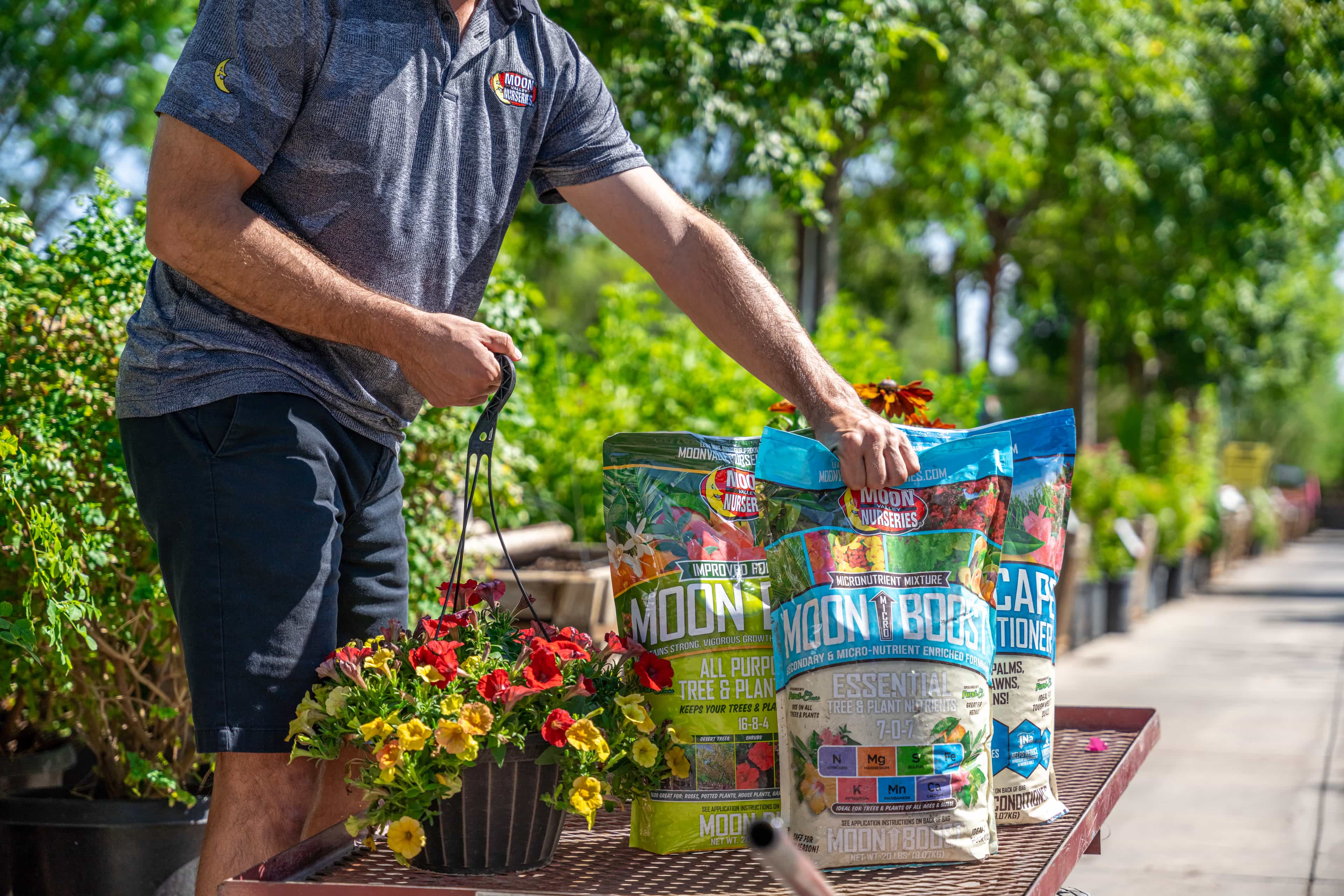 Man placing MVN Fertilizers on to a work cart in the nursery.